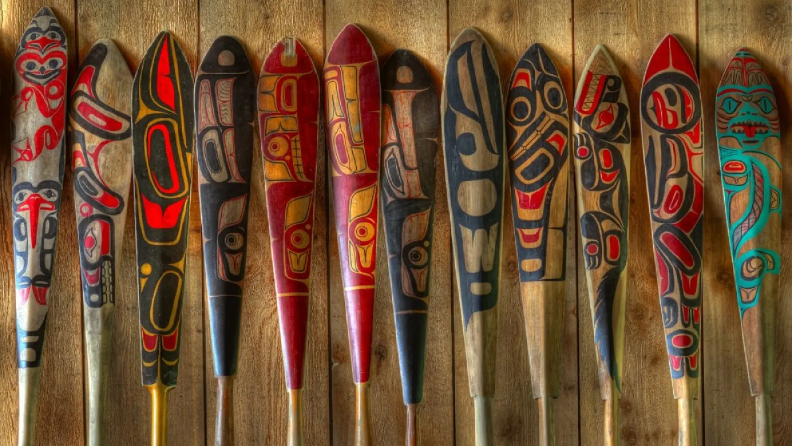 Hand-carved and vibrantly painted Haida paddles