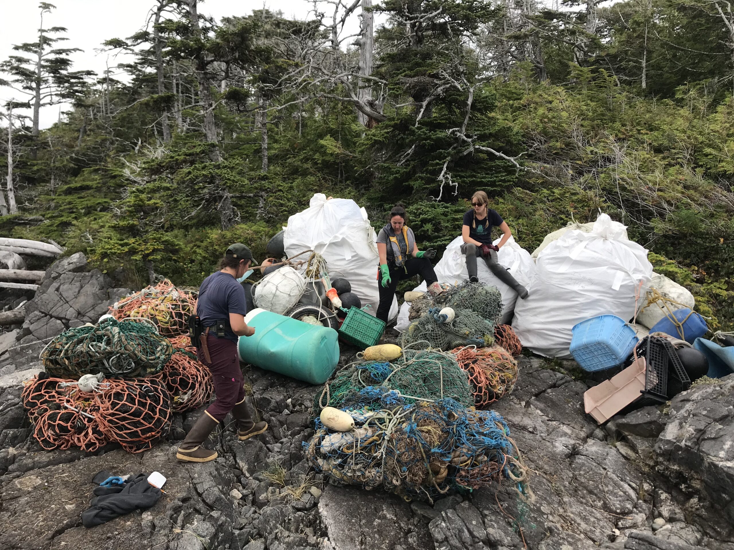 An assortment of marine garbage collected from the high water line. Nets, floats, plastic household items, and more.