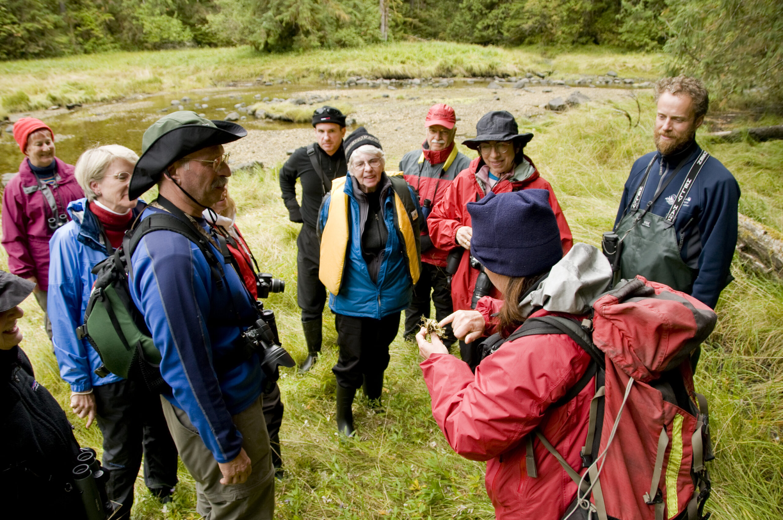 Bluewater Adventures guests gather in an estuary to learn from the Naturalist.