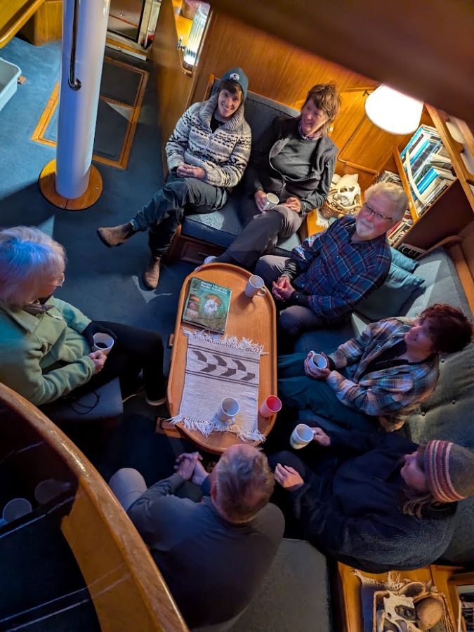 Guests enjoying morning coffee in the salon on Island Roamer.
